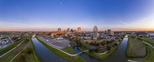 Aerial panorama picture of the Fort Worth skyline at sunset from west direction with sun reflections photo