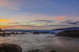 Long exposure picture of colorful sunset at Kamala beach in Thailand in summer photo