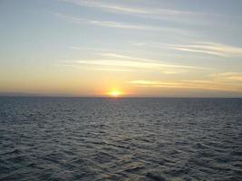 Image of sunset over the sea in clear weather photo