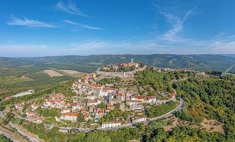 Drone panorama on historical Croatian town Motovun in Istria during daytime with clear sky and sunshine photo