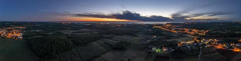 Drone panorama over Istrian Adriatic coast near Porec taken from high altitude at sunset photo