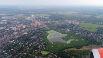 View from the airplane porthole to the big modern city of Moscow on a summer day video