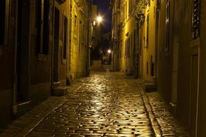 Scene of a cobblestoned street in the historic center of Rovinj in Croatia during night