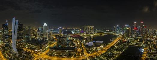Aerial panoramic picture of Singapore skyline and gardens by the bay during preparation for Formula 1 race in the night in autumn photo