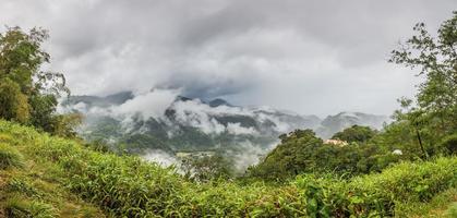 Panoramic picture of rainforest on Dominika island during stormy weather during daytime photo