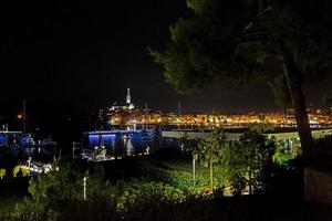 Picture of the illuminated historic part of Rovinj at night photo