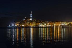 Picture of the illuminated historic part of Rovinj at night photo