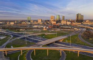 Aerial panorama picture of the Fort Worth skyline at sunrise with highway intersection in Texas photo