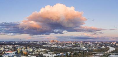 Aerial panoramic picture of river Main and the Frankfurt skyline during sunset in afterglow with illuminated cloud photo