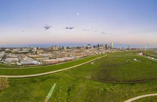 Panoramic aerial drone picture of Dallas skyline and Trammel Crow Park at sunset in winter photo