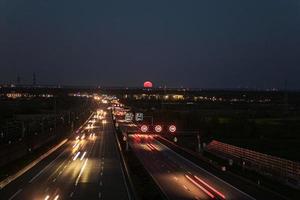 Image of Pink Moon rising over a German highway in April 2021 photo