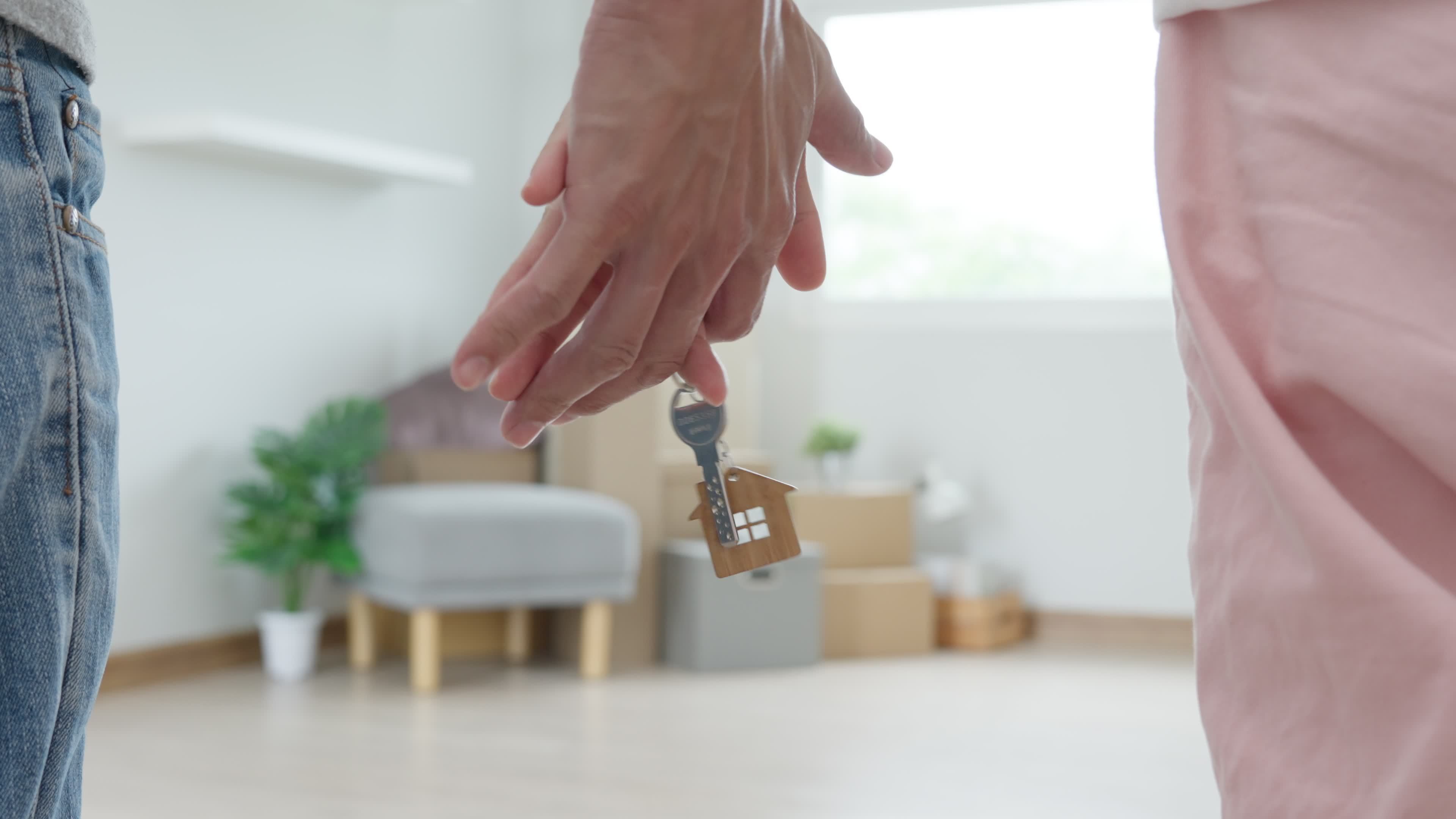 Moving house, relocation. Couple hold key house keychain in new