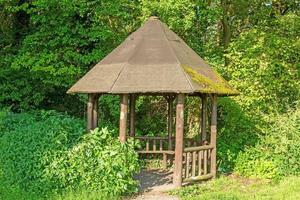 Image of a hiker's shelter in a forest path in summer photo