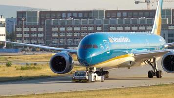 FRANKFURT AM MAIN, GERMANY JULY 21, 2017 - Vietnam Airlines Boeing 787 Dreamliner VN A868 towing by tractor to service. Fraport, Frankfurt, Germany video