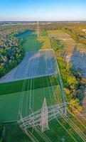 Panoramic image of high voltage road with high power poles in evening light photo