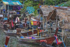 Typical Thai fishing boats in small harbor photo