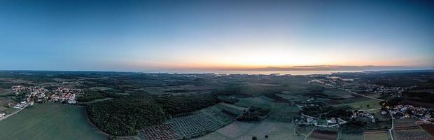 Drone panorama over Istrian Adriatic coast near Porec taken from high altitude at sunset photo