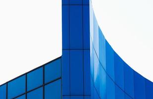 fragment of the wall of a modern blue building on a white background photo