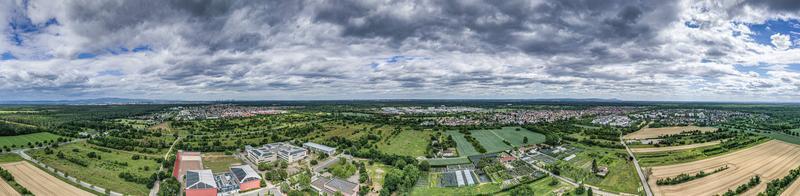 Panoramic drone picture of the city Moerfelden-Walldorf with the skyline of Frankfurt in the background at evening photo