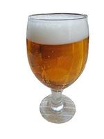 Picture of an exempted beer glass filled with beer and foam crown photo