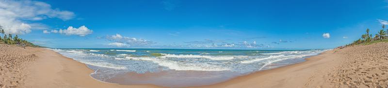 Panoramic view over the endless and deserted beach of Praia do Forte in the Brazilian province of Bahia during the day photo