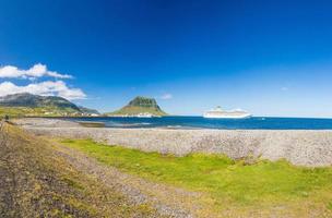 Panoramic view over bay of Grundarfjoerour with Kirkjufell mountain and cruise ships during daytime photo