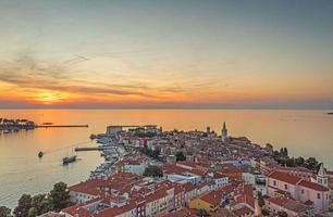 Drone panorama of Croatian coastal town Porec with harbor and promenade during sunrise photo