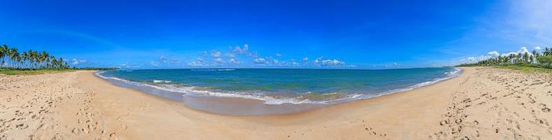 Panoramic view over the endless and deserted beach of Praia do Forte in the Brazilian province of Bahia during the day photo