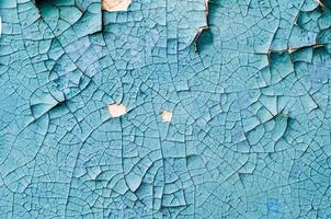 wall texture with cracked peeling blue paint photo