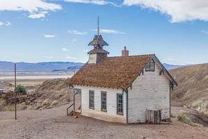 Image of an old fisty church from the wild west without people in front of blue sky photo