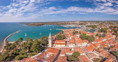 Drone panorama over the roofs of the Croatian coastal town of Novigrad with harbor and church during daytime photo