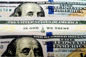 bill hundred US dollars closeup phrase in god we trust photo