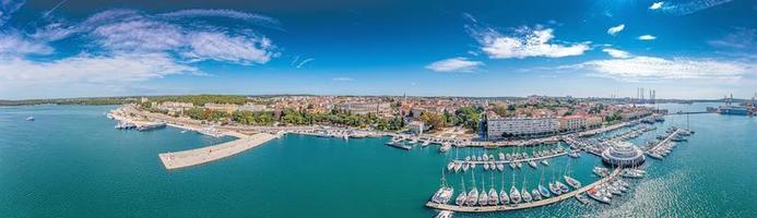 Drone panorama of the Croatian coastal city of Pula taken during the day above the harbor photo