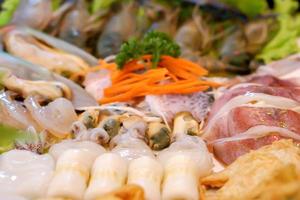 Close up and crop variety of seafood set for sukiyaki. photo