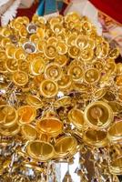 Look up view of of many small golden bells was hung in a group in Thai temple. photo