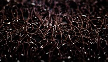 texture pattern of dark brown rubber on a black background photo