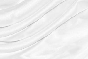 Smooth elegant white silk or satin luxury cloth texture can use as wedding background. Luxurious background design photo