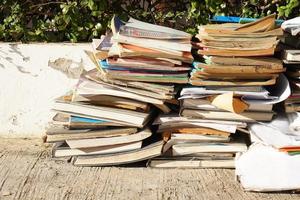 Stacks of old papers and books waiting to be recycled.