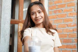 Asian woman smiling happily in a cafe photo