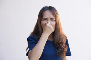 Asian women cover their noses with their hands because they smell bad. photo