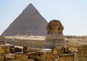 Sphinx statue and Cheops pyramid in Giza Egypt photo