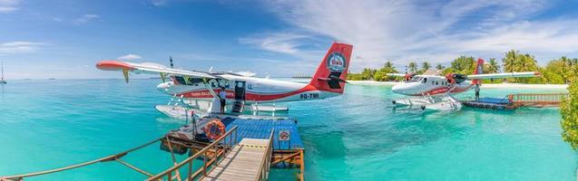 05.19.2019 - Ari Atoll, Maldives Exotic scene with Trans Maldivian Airways seaplane on Maldives sea landing. Vacation or holiday in Maldives concept background. Summer vacation transportation photo