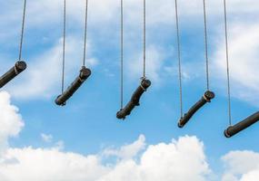 rope ladder against a blue sky and clouds photo
