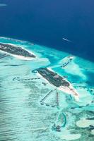 Luxury travel landscape, Maldives aerial view, tropical resort or hotel on paradise island. Luxurious water villas and white sandy beach with palm trees and perfect sea. Summer travel vacation holiday photo