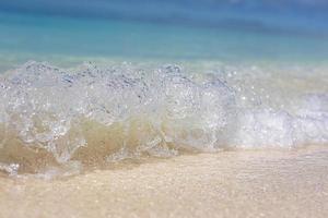 Tropical sea and sand under the blue sky. Tropical beach landscape. Soft blue ocean wave on clean sandy beach. Ocean wave background. White sand and crystal-blue sea. Ocean water nature, beach relax photo