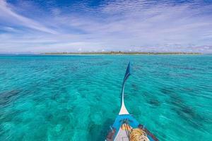 Inspirational Maldives beach design. Maldives traditional boat Dhoni and perfect blue sea with lagoon. Luxury tropical paradise concept. Exotic travel landscape, seascape in Maldives photo