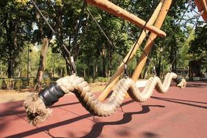 Wooden modern ecological safety children outdoor playground equipment in public park. Nature architecture construction playhouse in city. Children rest and childhood concept. Idea for games on air. photo