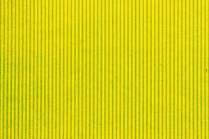 Abstract paper yellow geometric symmetrical texture striped surface vertical lines background. Structure design cardboard shape backdrop. Holiday spring decoration interior concept. Flatlay, close-up photo