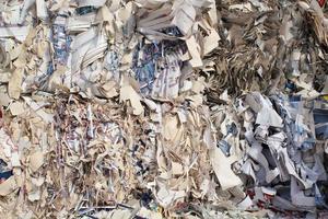 Waste pile for recycling on sorting plant. Technology reuse materials. Stack of shredded paper. Save the planet ecology concept. Industry reduced pollution factory photo