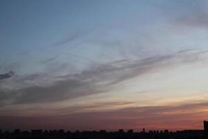 Colorful cloudy twilight beautiful sky cityscape sunset and morning sunrise. Dramatic evening night early morning view with city buildings silhouette. Panoramic background concept. Copy space for text photo